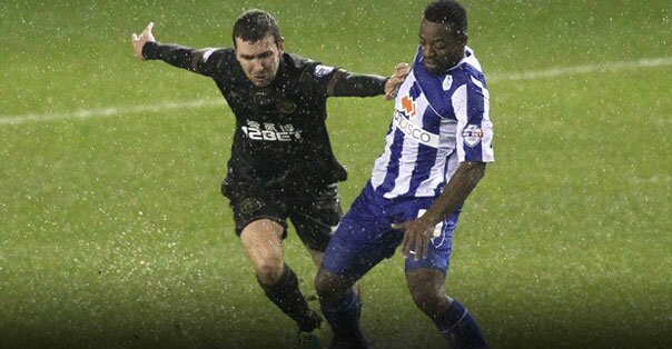 A soccer game being played in heavy rain